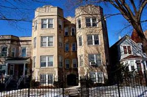 Chicago apartment for rent - an apartment building with a fence in front of it