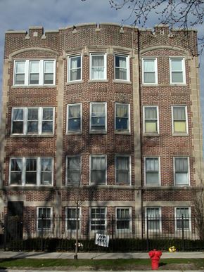 Chicago apartment for rent - a red fire hydrant in front of a brick building
