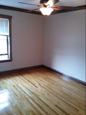 Chicago apartment for rent - an empty room with wooden floors and a window