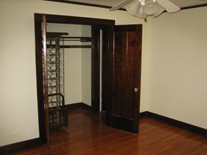 Glen Ellyn apartment for rent - a closet in a living room with a wooden floor and a closet door open