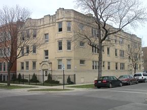 Chicago apartment for rent - a large building with cars parked in front of it