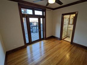 Chicago apartment for rent - an empty living room with a wood floor and doors