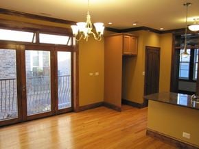 Chicago apartment for rent - an empty living room with a sliding glass door to a balcony