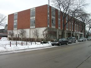 Lake Forest apartment for rent - a large brick building with cars parked outside in the snow