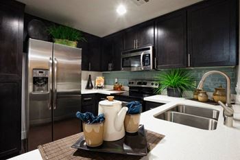 Upgraded stainless appliances and travertine tile