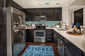 Los Angeles apartment for rent - A modern kitchen with dark wood cabinets and stainless steel appliances.
