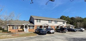 Lakeland apartment for rent - a house with cars parked in a parking lot