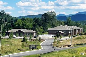 Blairsville apartment for rent - an aerial view of a building with mountains in the background