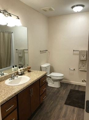 Blairsville apartment for rent - a bathroom with a toilet and a sink and a mirror
