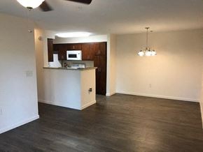 Blairsville apartment for rent - an empty living room and kitchen with wood flooring