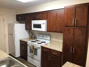 Blairsville apartment for rent - a kitchen with a stove microwave and refrigerator