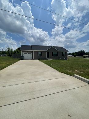Oak Grove house for rent - A house with a grey roof and a driveway in front.