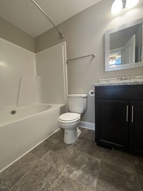 Oak Grove house for rent - A bathroom with a toilet, sink, and bathtub.