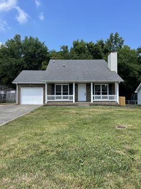 Clarksville house for rent - A house with a grey roof and a white chimney.