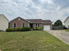 Clarksville house for rent - A house with a brown roof and a white garage door.