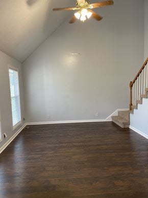 Clarksville house for rent - A room with wooden floors and a staircase.