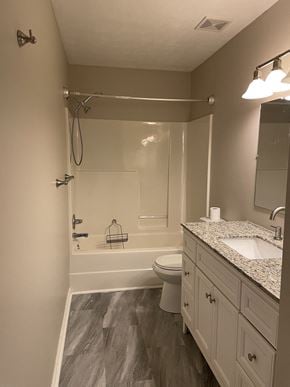 Clarksville house for rent - A bathroom with a toilet, sink, and shower.
