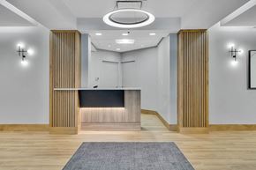 Cambridge apartment for rent - a lobby with a reception desk and a rug