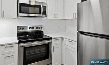 Cambridge apartment for rent - a white kitchen with a stove microwave and refrigerator