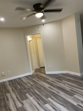 San Diego apartment for rent - A room with a ceiling fan and light fixture.