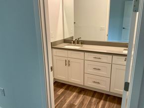 Orlando apartment for rent - a bathroom with white cabinets and a sink and a mirror