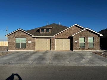 Odessa house for rent - a brick house with a garage and a blue sky