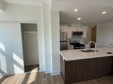 Kanata apartment for rent - A kitchen with a sink and a refrigerator.