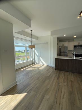 Kanata apartment for rent - A modern kitchen with wooden floors and a large window.