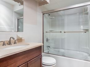 Delaware apartment for rent - A modern bathroom with a glass shower stall and a white toilet.