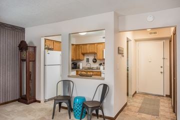 Delaware apartment for rent - A kitchen area with a refrigerator, a chair, and a table.