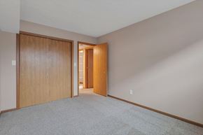 Delaware apartment for rent - A room with a carpeted floor and two wooden doors.