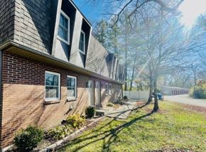 Delaware apartment for rent - a brick house with a sidewalk in front of it
