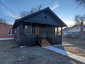 Great Falls house for rent - the front of a black house with a porch and stairs