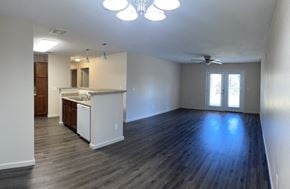 Milledgeville apartment for rent - an empty living room with a kitchen and a ceiling fan