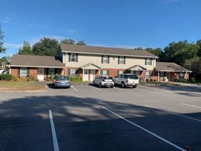 Lake Park apartment for rent - a parking lot with cars in front of a house