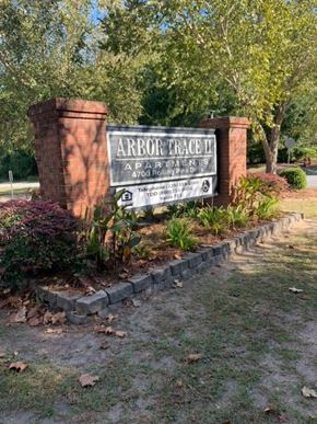 Lake Park apartment for rent - a sign for arbor trace park in front of a brick wall