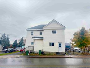Stellarton apartment for rent - a white house on the corner of a rainy street