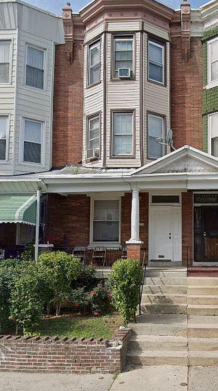 Philadelphia apartment for rent - a house with a porch and a white door