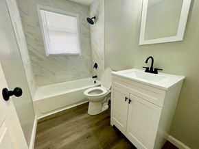 Louisville house for rent - a bathroom with a toilet and a sink and a bath tub