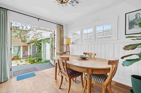 Santa Monica house for rent - a dining room with a table and chairs and a sliding glass door to a patio