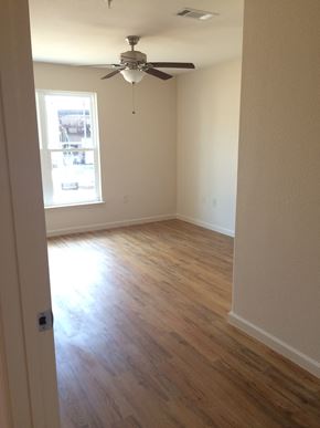 Young Harris apartment for rent - an empty living room with wooden floors and a ceiling fan