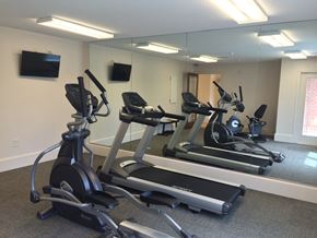 Young Harris apartment for rent - a gym with several exercise bikes and a tv