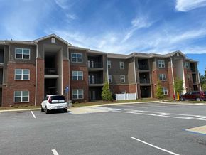 Columbus apartment for rent - an apartment building with a car parked in a parking lot