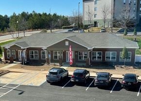 Columbus apartment for rent - a parking lot with cars in front of a house