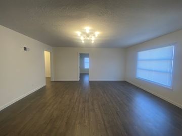 Elm Creek apartment for rent - an empty living room with wood floors and a large window