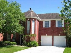 Sugar Land house for rent - a red brick house with a white garage door