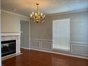 Sugar Land house for rent - a living room with a fireplace and a chandelier