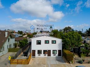 San Diego apartment for rent - a view of a white building with a sign on top of it