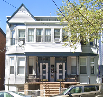 Jersey City apartment for rent - a blue and white house with a car parked in front of it
