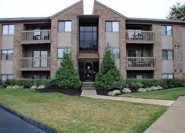 Fairfield house for rent - a brick apartment building with two trees in front of it